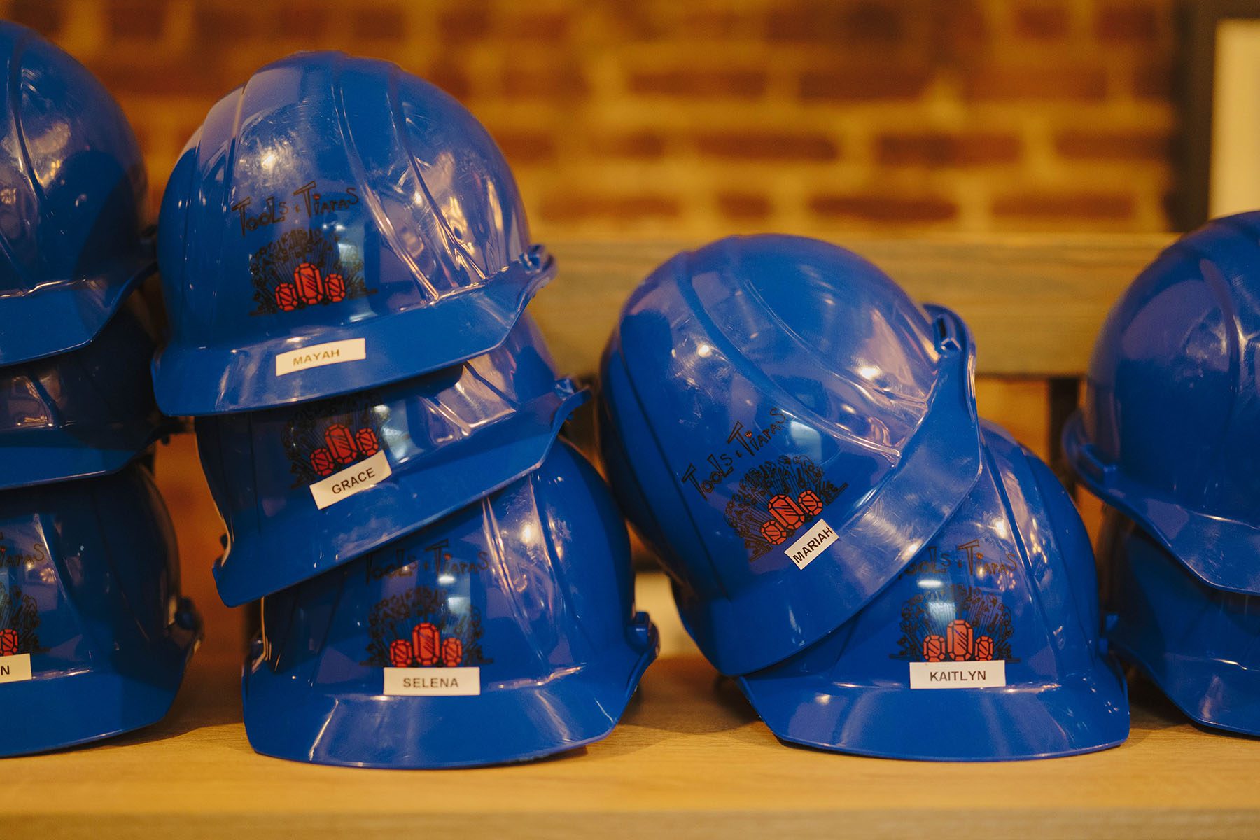 Hardhats labeled with girls' names are seen at a Tools & Tiaras workshop.