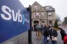 Customers and bystanders form a line outside a Silicon Valley Bank branch location.