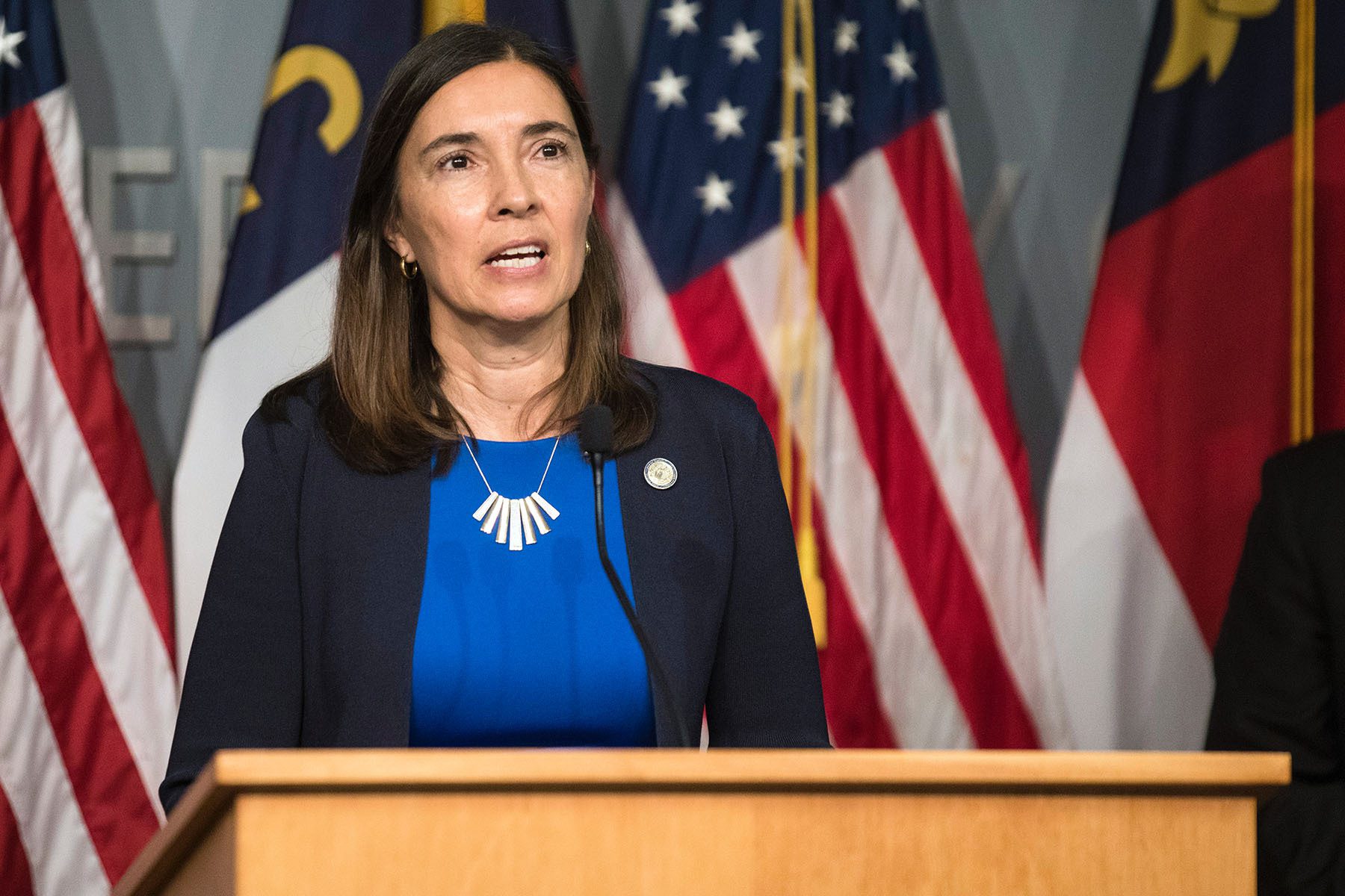 Supreme Court Justice Anita Earls at a podium speaking at a conference speaking about the goals of the North Carolina Task Force for Racial Equity