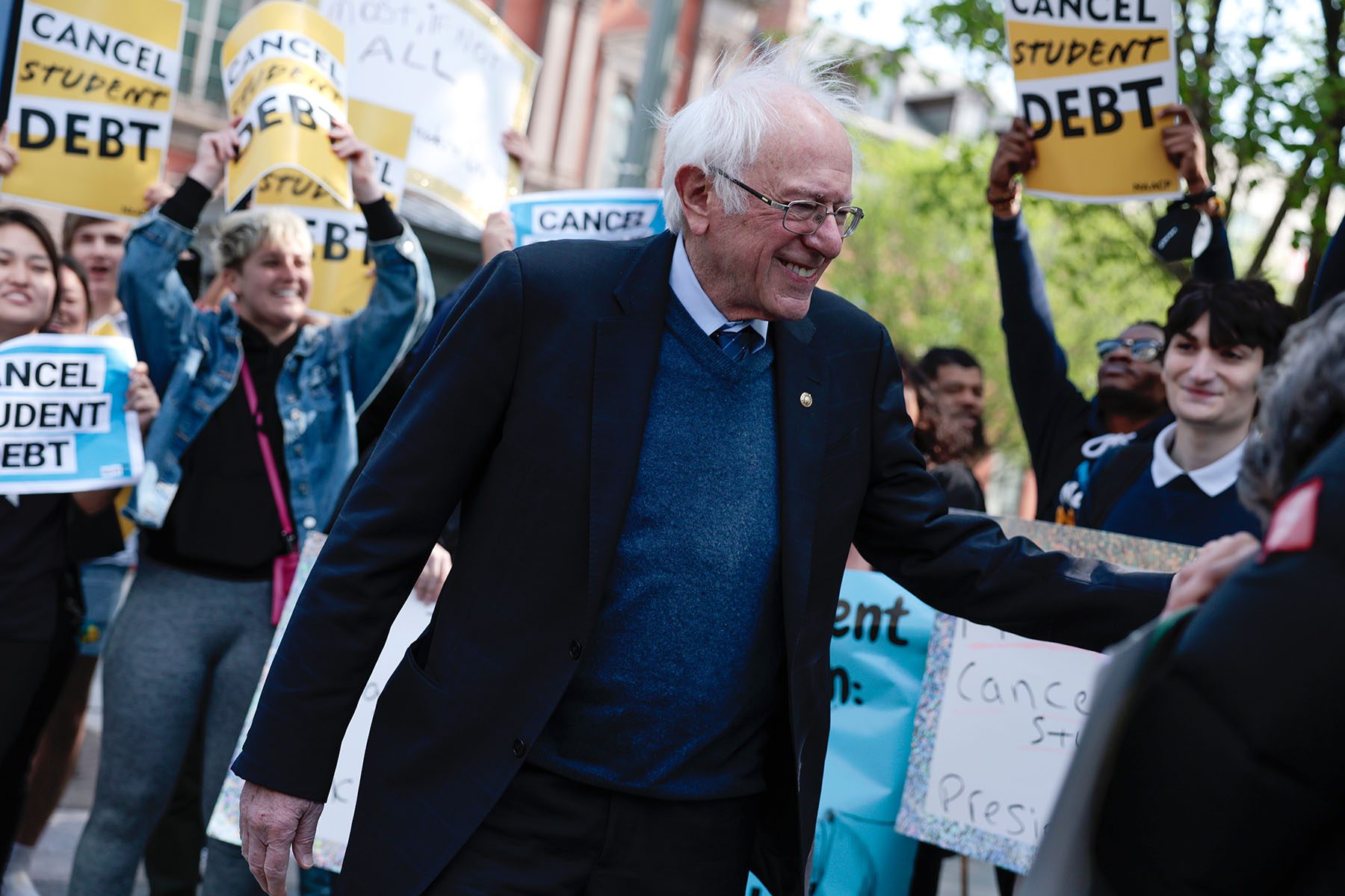 Sen. Bernie Sanders waves after speaking at a Student Loan Forgiveness.