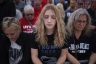 Three women are seen closing their eyes in prayer prior to a rally featuring former President Trump.