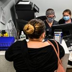 Woman at a counter checking in for her appointment to get an abortion.