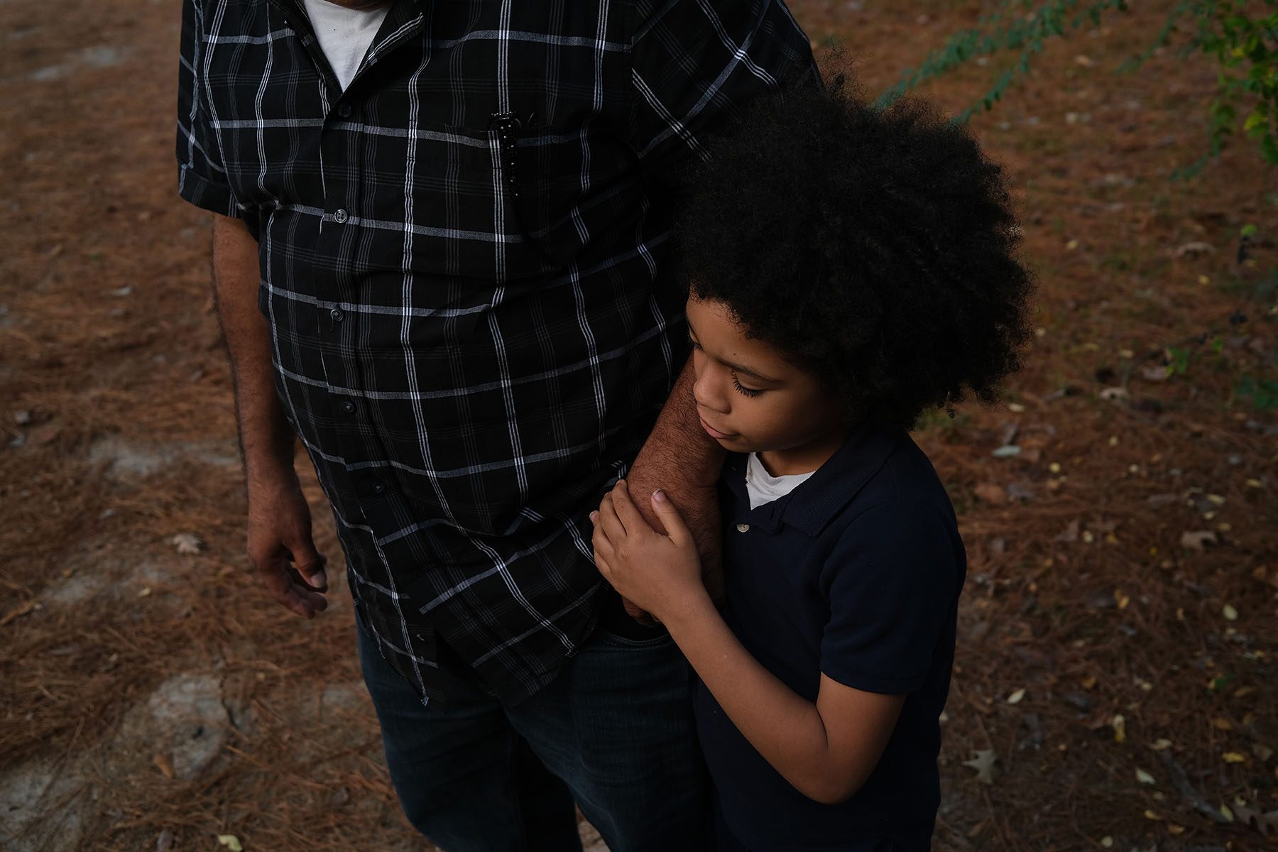 A father holds his son's hand outside their home in Jackson, Mississippi.