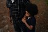 A father holds his son's hand outside their home in Jackson, Mississippi.