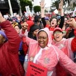 Los Angeles school workers walk in a strike for fair wages.