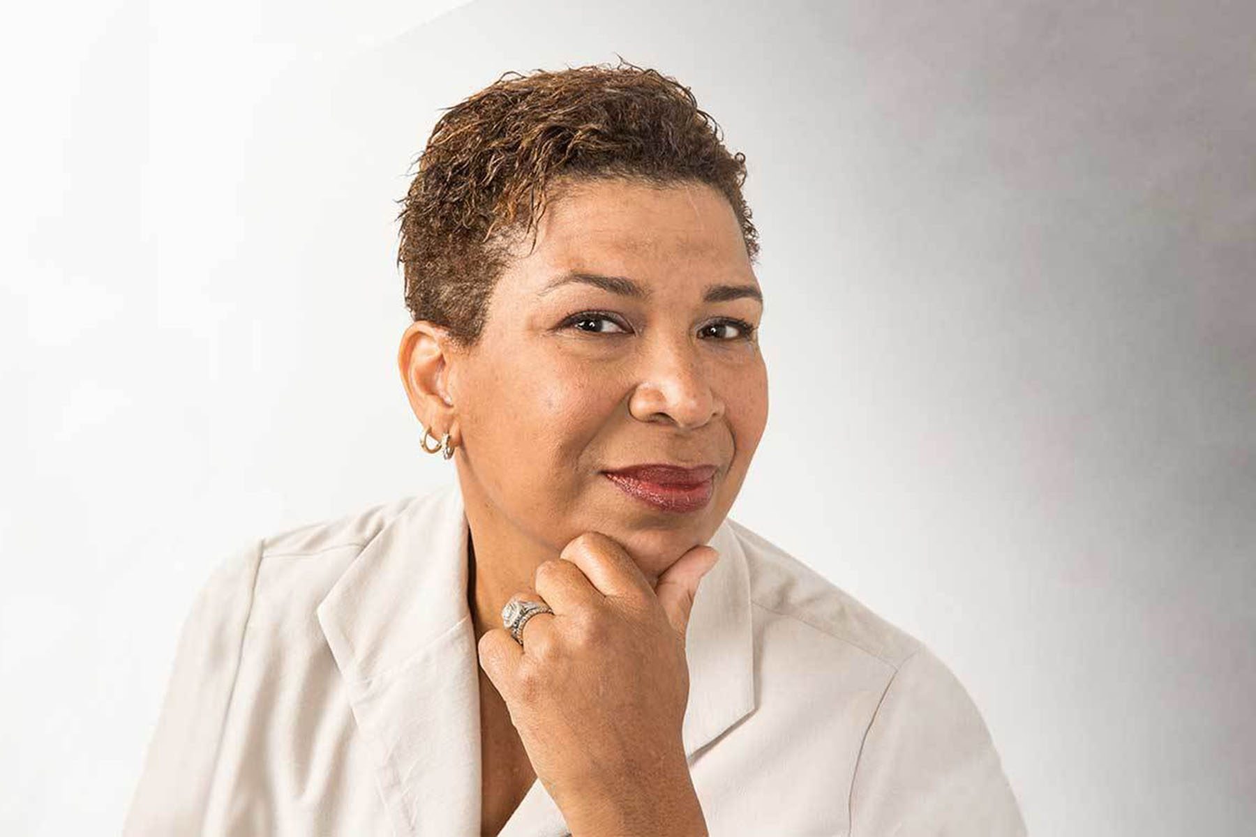 Portrait of Michel Martin holding her chin and smiling faintly.