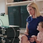 A still from Breaking The News shows 19th co-founder and CEO Emily Ramshaw getting ready for an interview with her young daughter by her side.