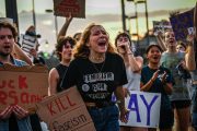 LGBTQ+ rights supporters protest against Florida Gov. Ron DeSantis outside a campaign event.