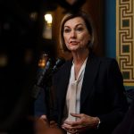 Iowa Gov. Kim Reynolds speaks with journalists at The Iowa State Capitol in Des Moines, Iowa in March 2022.