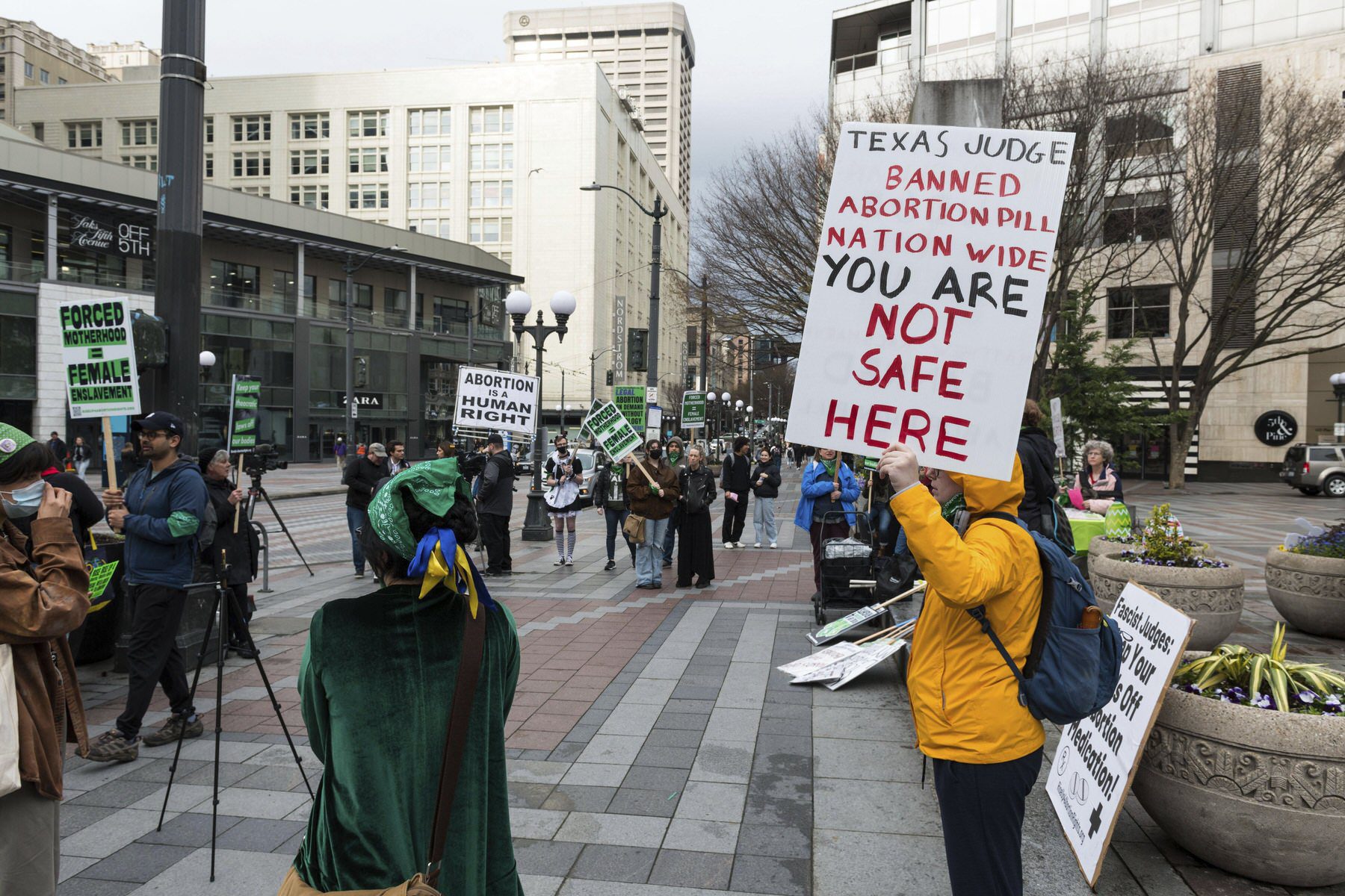 Protesters hold signs opposing the judge's opinion on mifepristone in Seattle