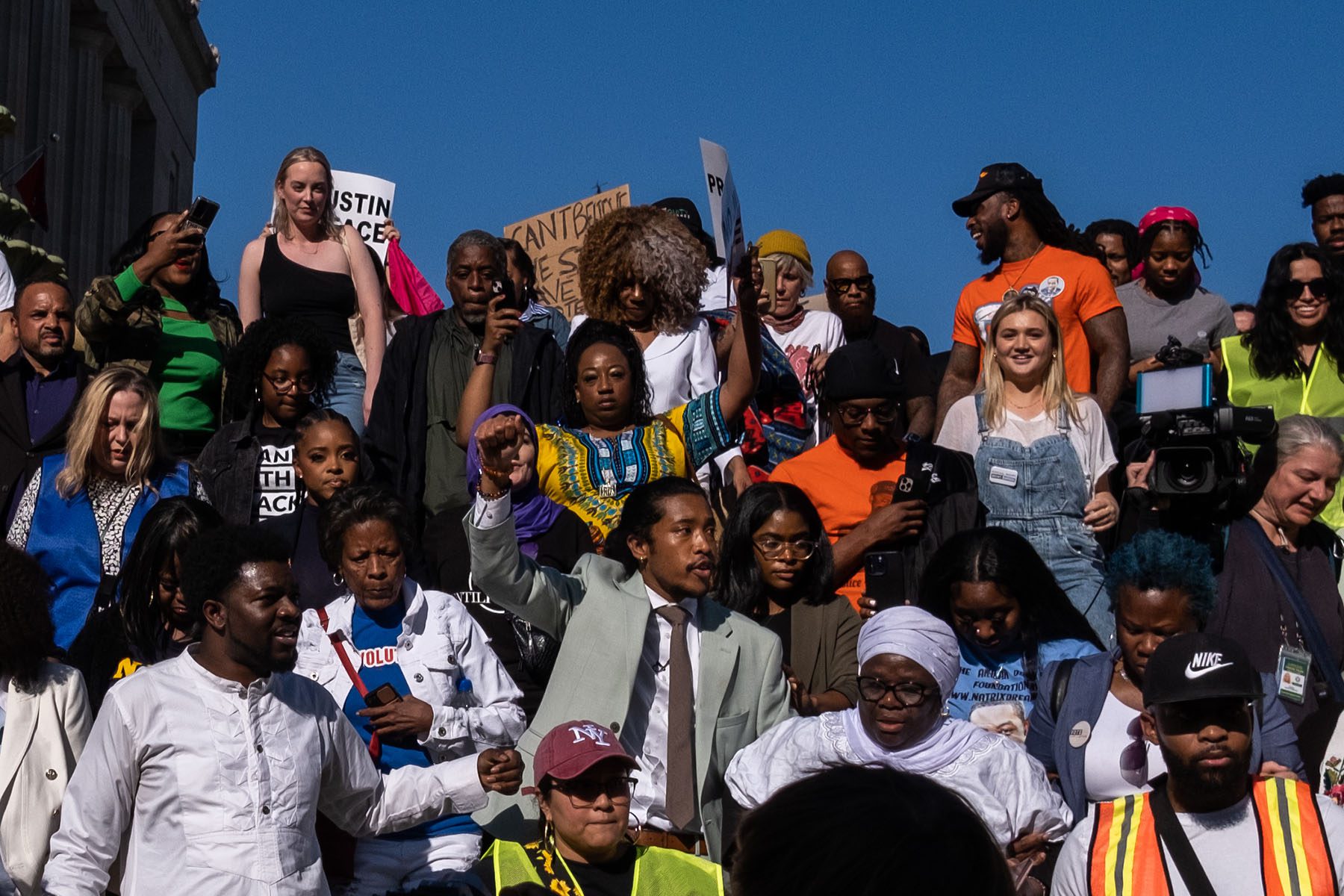 State Representative Justin Jones walks to the Tennessee State Capitol while surrounded by supporters.