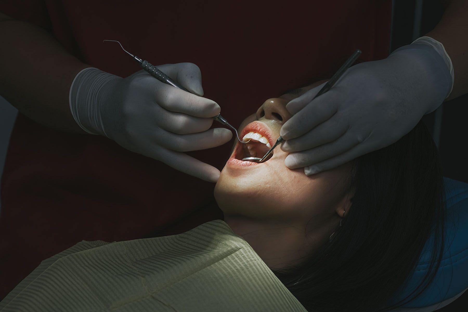 close up of a female patient with open mouth during a dental check up.