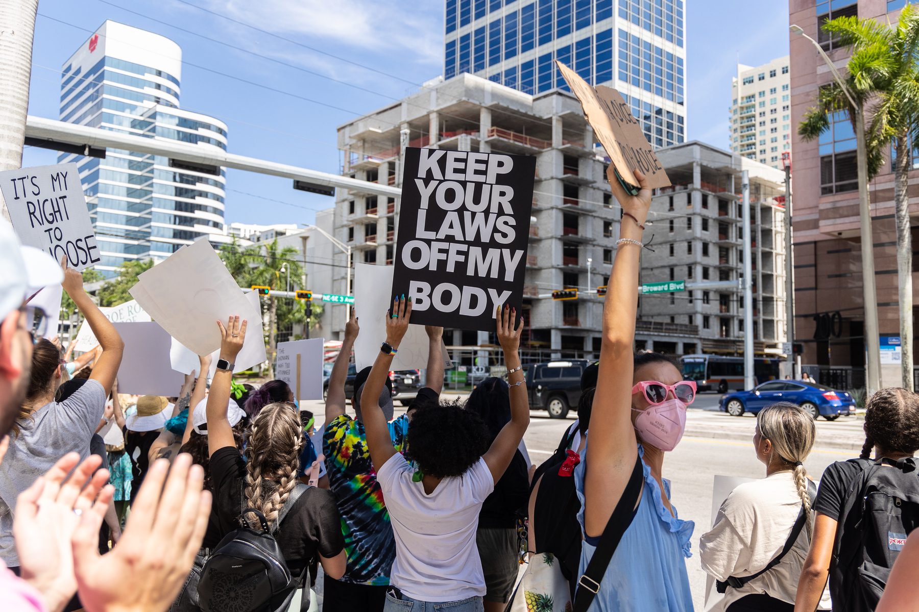 A person in a crowd holds a sign in support of abortion access.