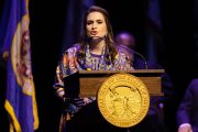 Peggy Flanagan delivers a speech from a podium after being sworn in.