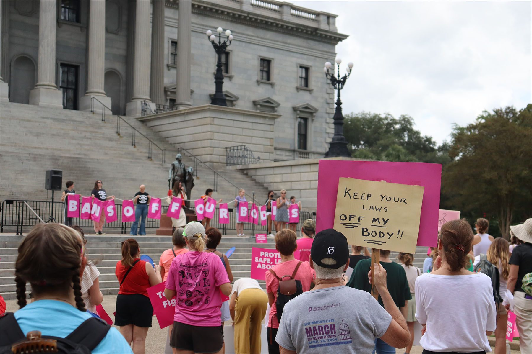 Protesters gather outside the state house in opposition to a proposed abortion ban.