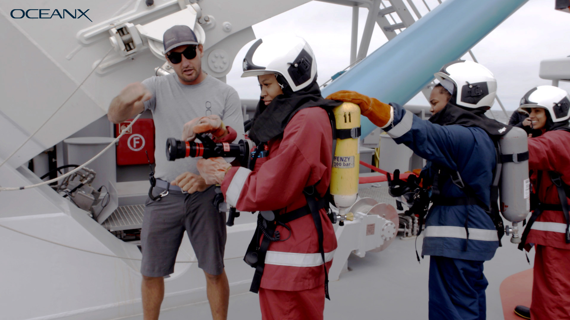 Students are seen manning equipment on the deck of OceanXplorer.