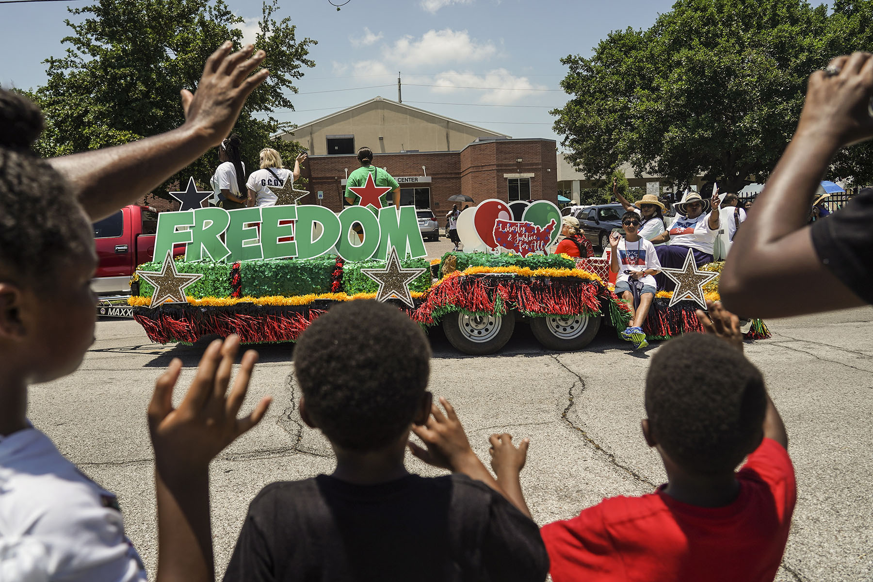 Spectators watch a Juneteenth Parade on June 19, 2021 in Galveston, Texas.