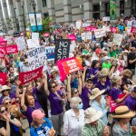 Abortion rights supporters watch North Carolina Gov. Roy Cooper sign a veto against the law that bans abortion after 1st trimester.