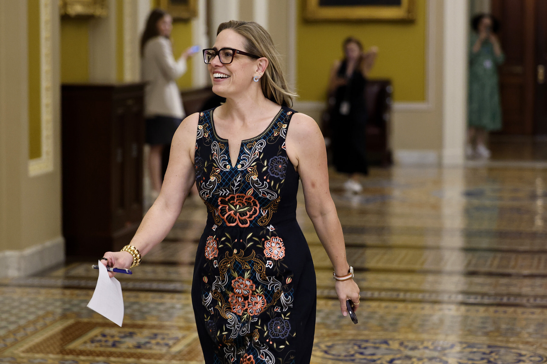 Sen. Kyrsten Sinema walks through the Capitol