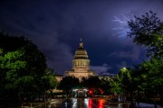 Lightning flashes behind the Texas State Capitol in April 2023 in Austin, Texas.