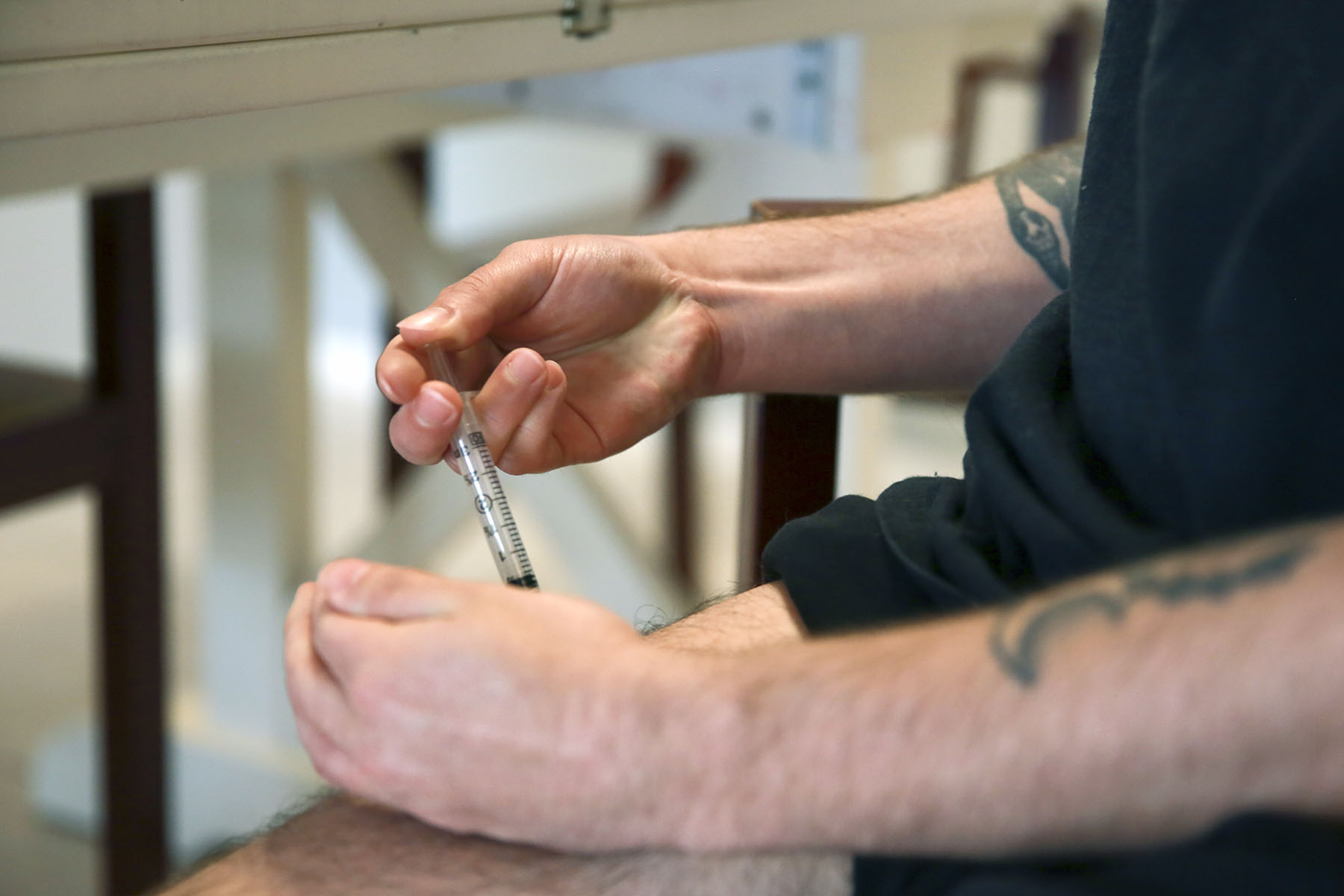 Lucas injects his weekly testosterone shot as part of his hormone therapy.