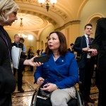 Tammy Duckworth speaks to members of the press on Capitol Hill.