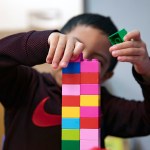 A child plays with a lego set at a daycare.