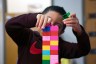 A child plays with a lego set at a daycare.