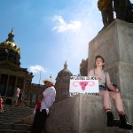 An abortion rights protester waits for the start of a rally for reproductive freedom on at the Iowa State Capitol Building. They hold a sign that reads 