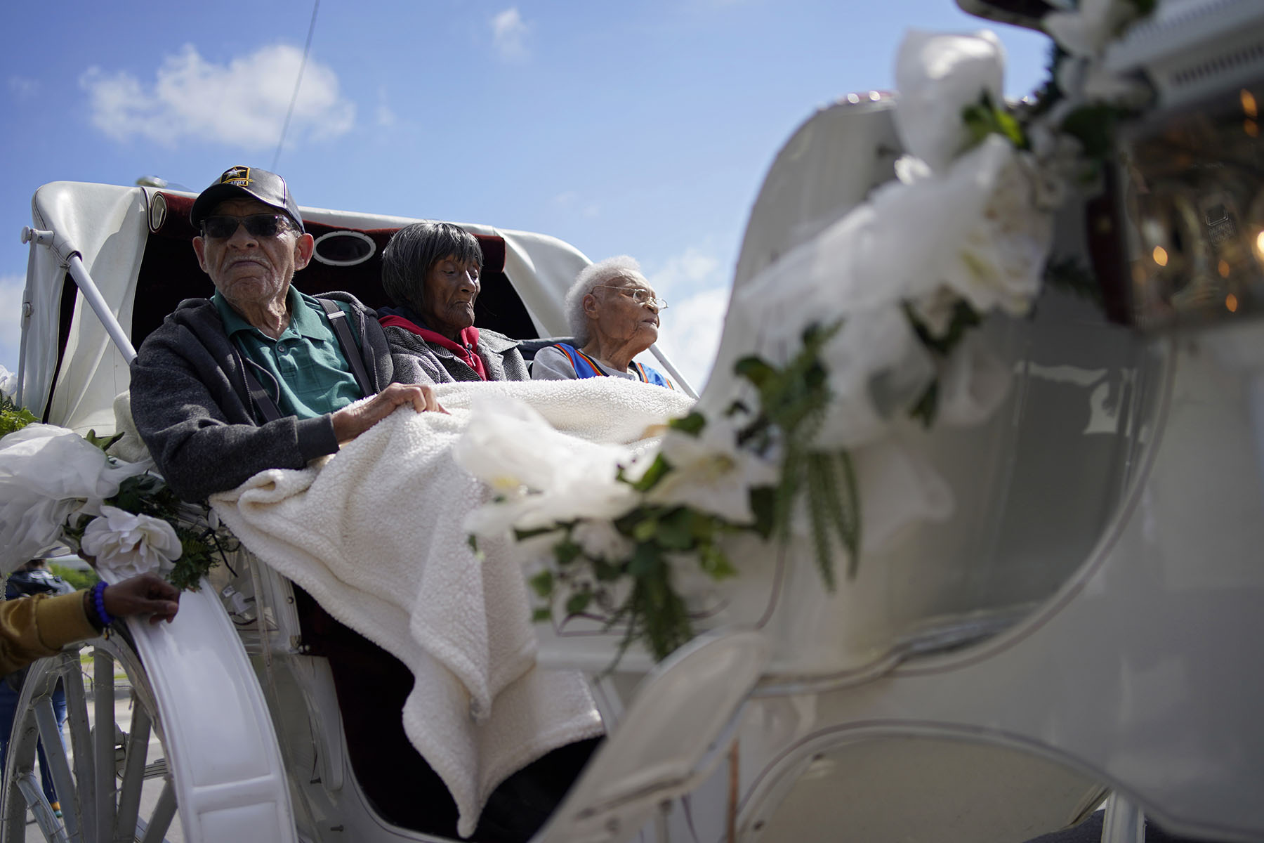 Tulsa Race Massacre survivors from left, Hughes Van Ellis, Lessie Benningfield Randle and Viola Fletcher ride in a carriage at a remembrance walk during centennial commemorations of the Tulsa Race Massacre.