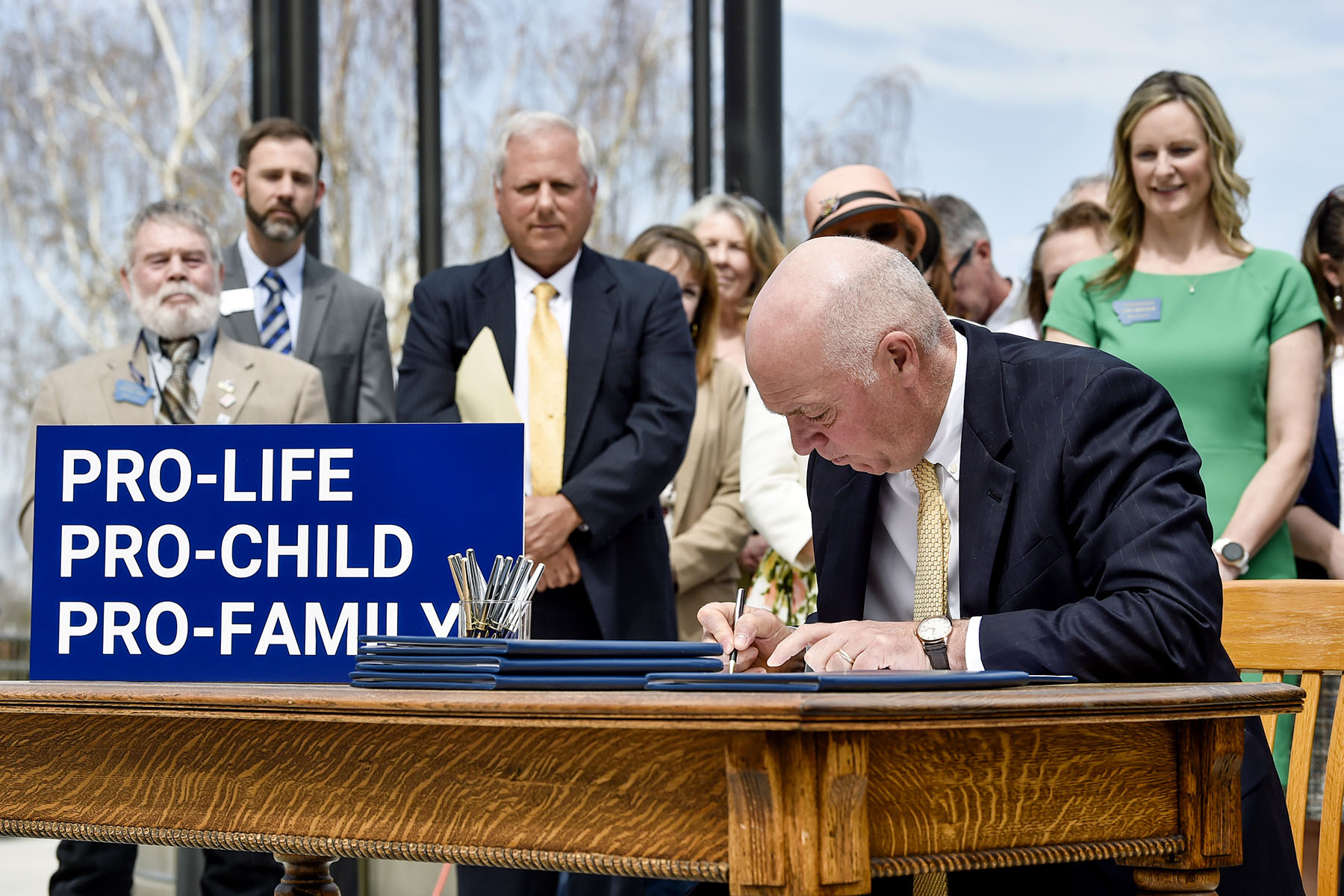 Montana Gov. Greg Gianforte signs a suite of bills aimed at restricting access to abortion during a bill signing ceremony on the steps of the state Capitol.