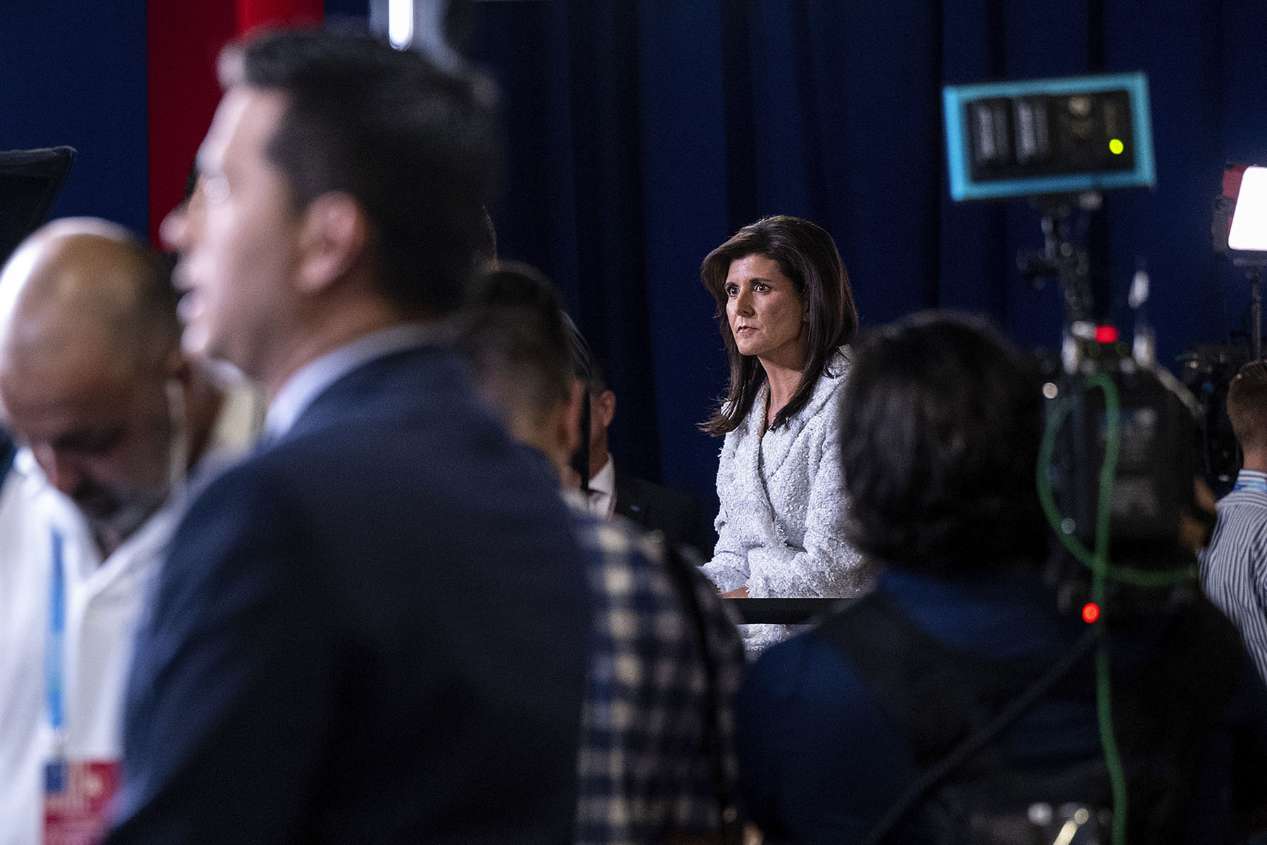 Nikki Haley sits in a room surrounded by people and cameras as she appears on Hannity following the first Republican Presidential primary debate.