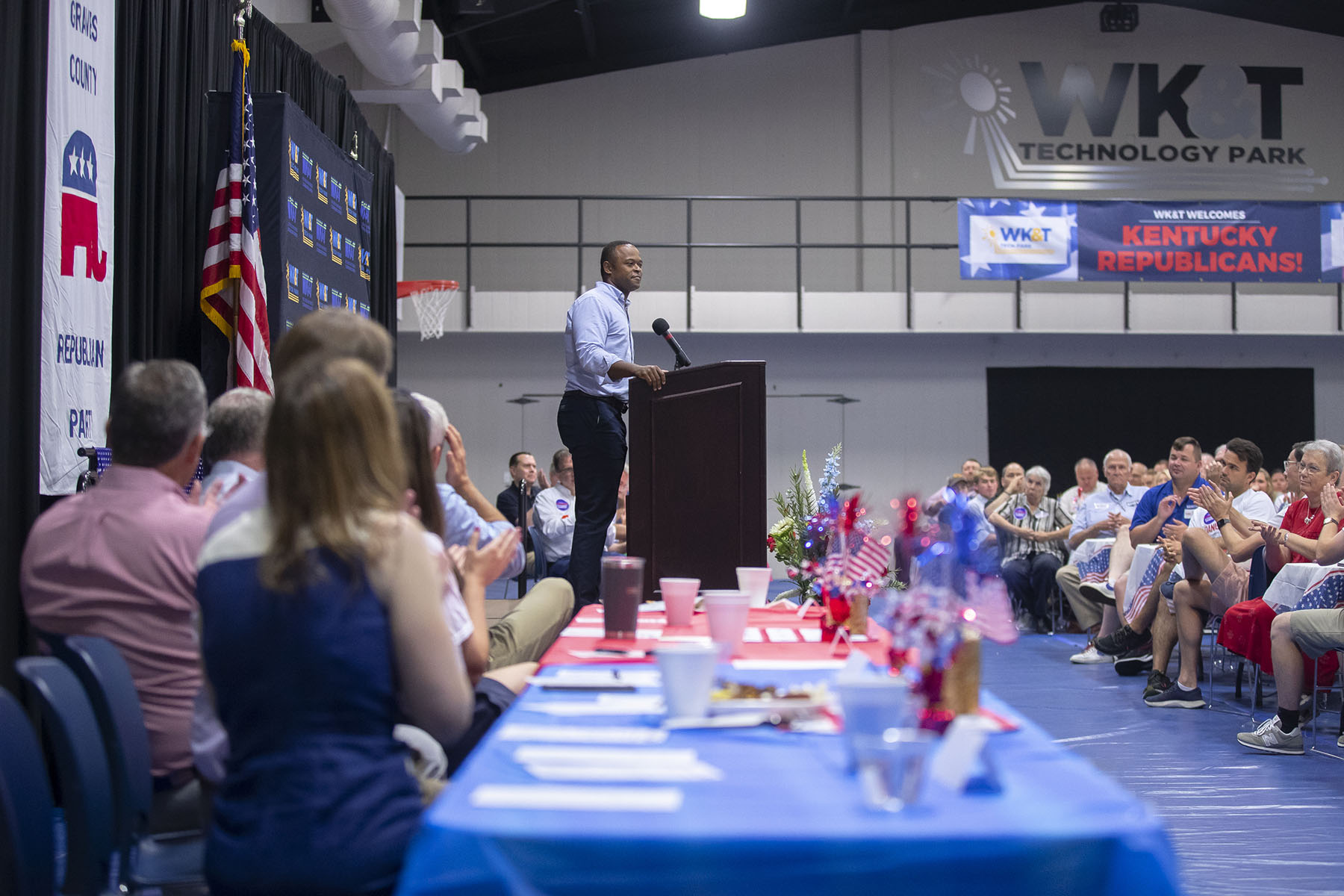 Daniel Cameron speaks at a podium in front of an audience.