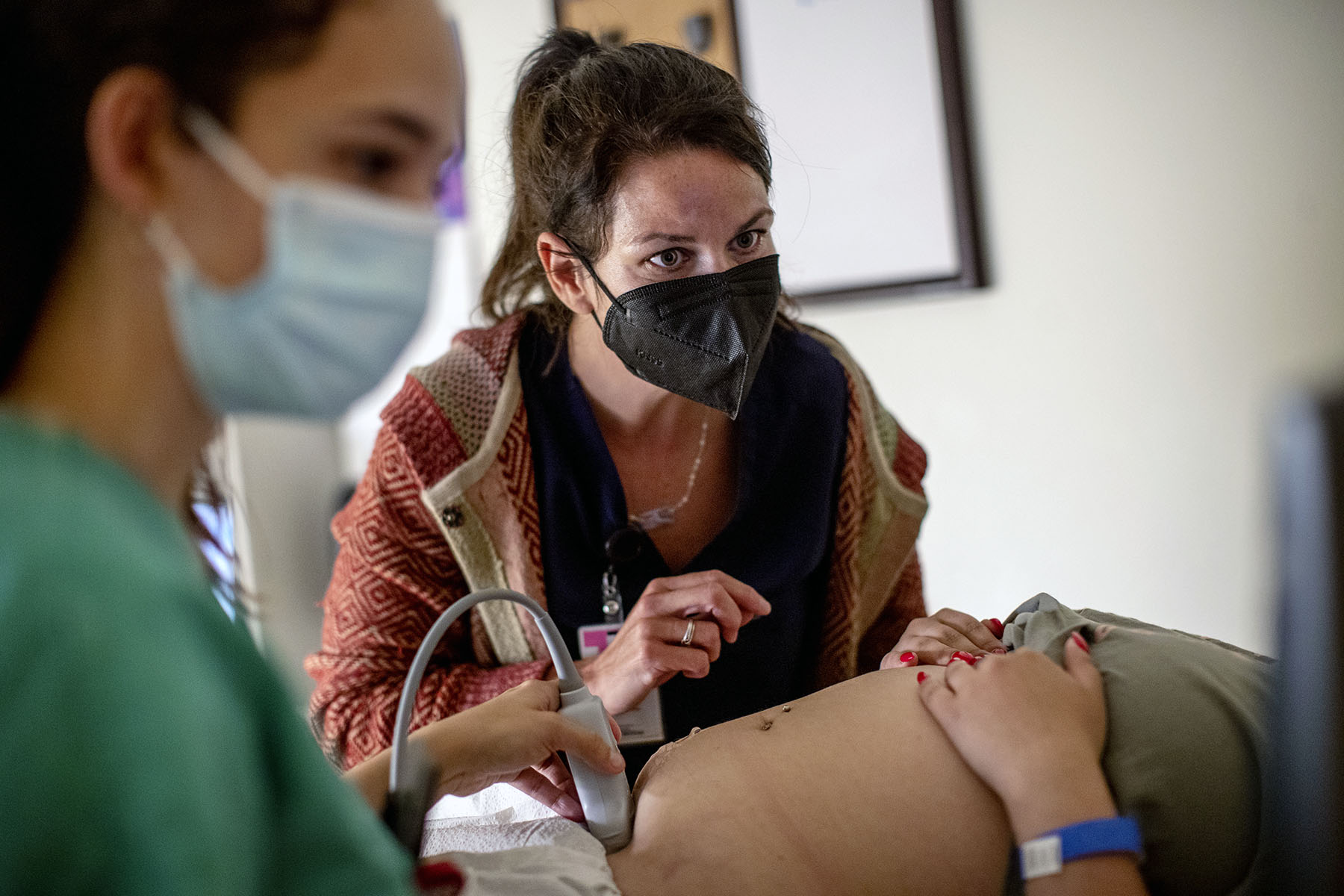 A family physician and her resident perform an ultrasound at the Center for Reproductive Health clinic.