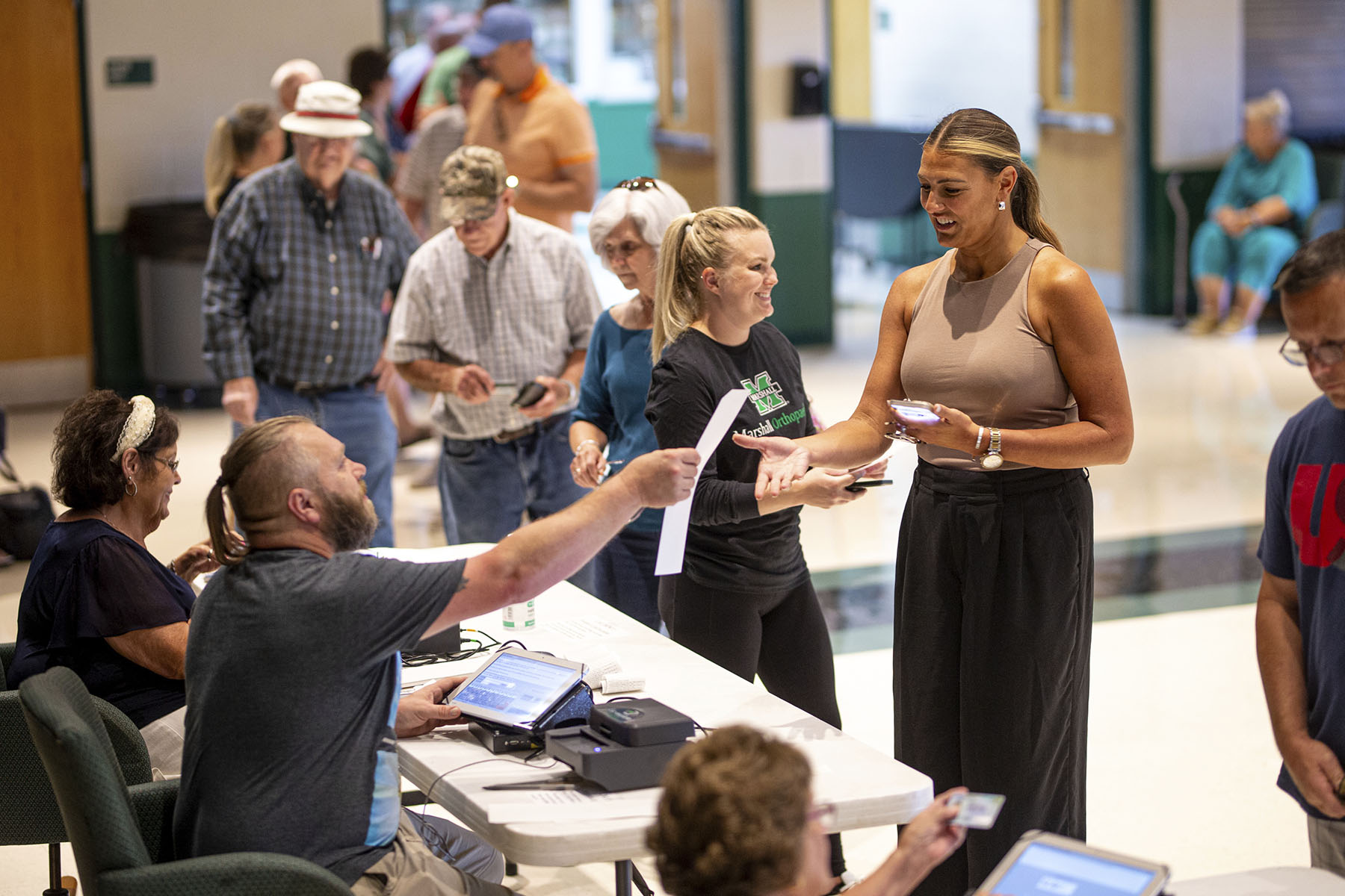 Voters receive their ballots as they vote on Ohio Issue 1 during a special one-issue election.