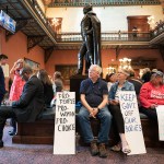 Demonstrators watch a live video feed of state Senate proceedings before the body passed a ban on abortion after six weeks of pregnancy.