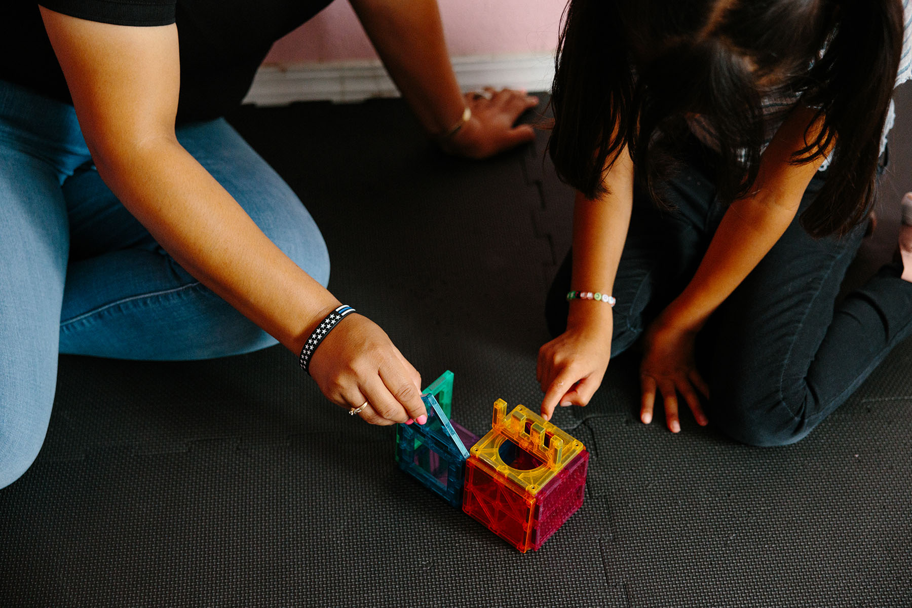 Adriana Lorenzo and her daughter play with toys at The Lorenzo Family Child Care.