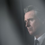 California Governor Gavin Newsom listens during the Milken Institute Global Conference.