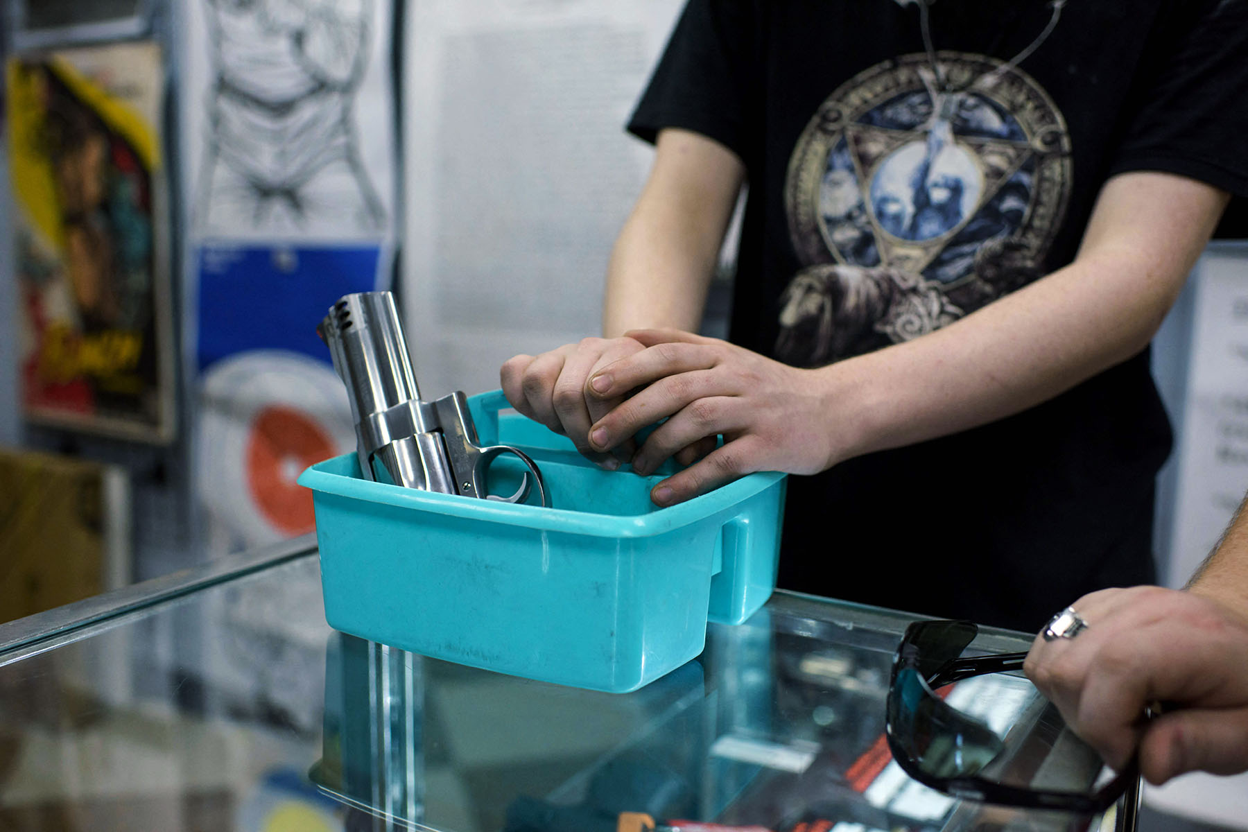 A customer waits to try out a pistol at Full Armor Firearms store.