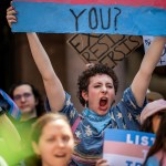 People chant while protesting anti-trans bills at the Texas State Capitol.