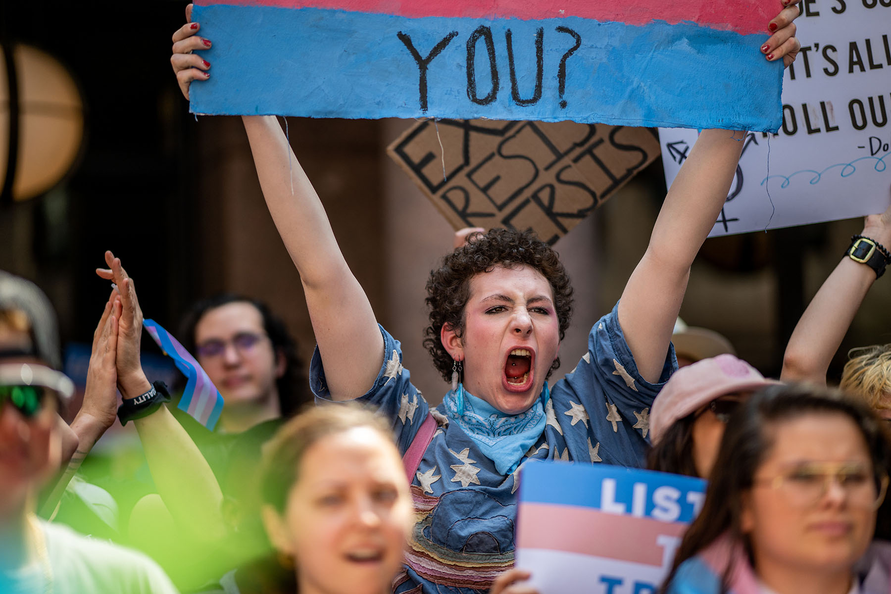 People chant while protesting anti-trans bills at the Texas State Capitol.