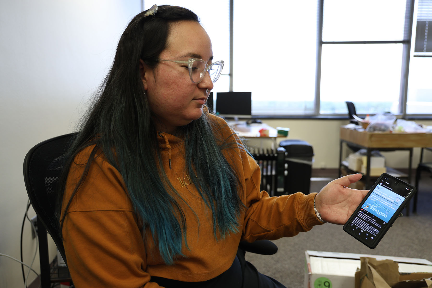 Jonnette Paddy, director of Indigenous Women Rising’s abortion fund, shows a social media post on her phone.