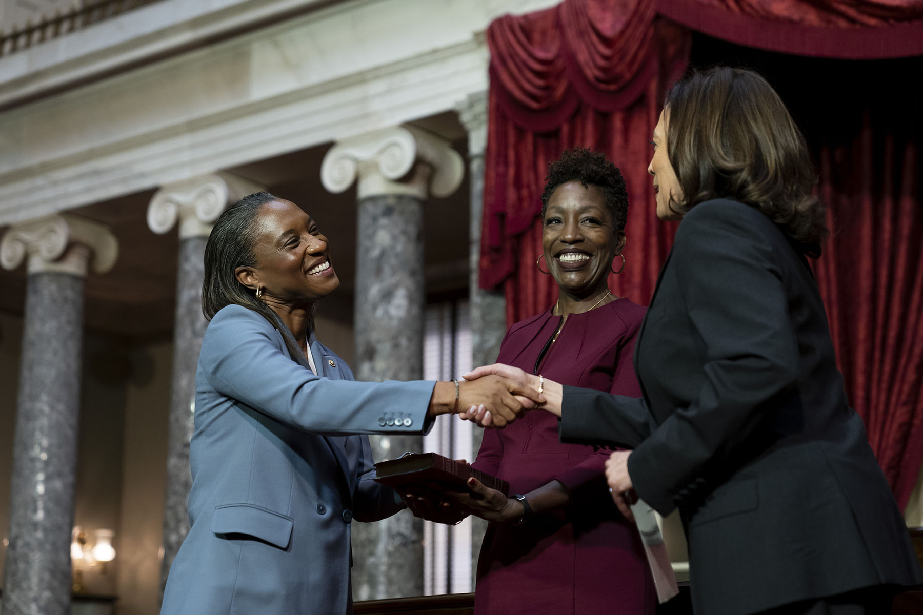 Vice President Kamala Harris swears in Laphonza Butler to the Senate as Butler's wife, Neneki Lee, holds the Bible.