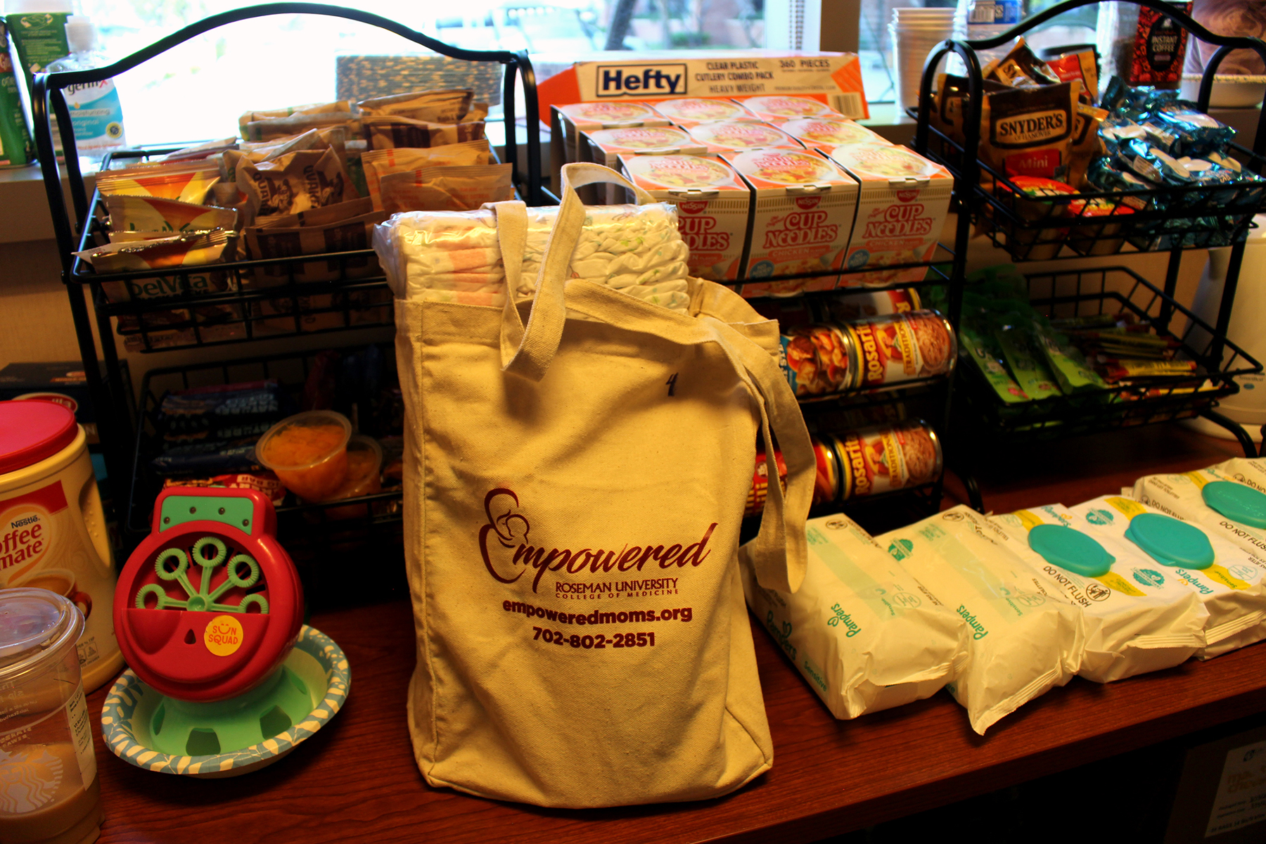 A tote bag full of baby diapers and wipes for a client.