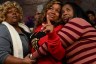 Breonna Taylor's mother, Tamika Palmer, cries as she stands with her friend Tooshy Hamilton (left) and sister Stephanie Baskin during an unveiling of a Breonna Taylor painting.