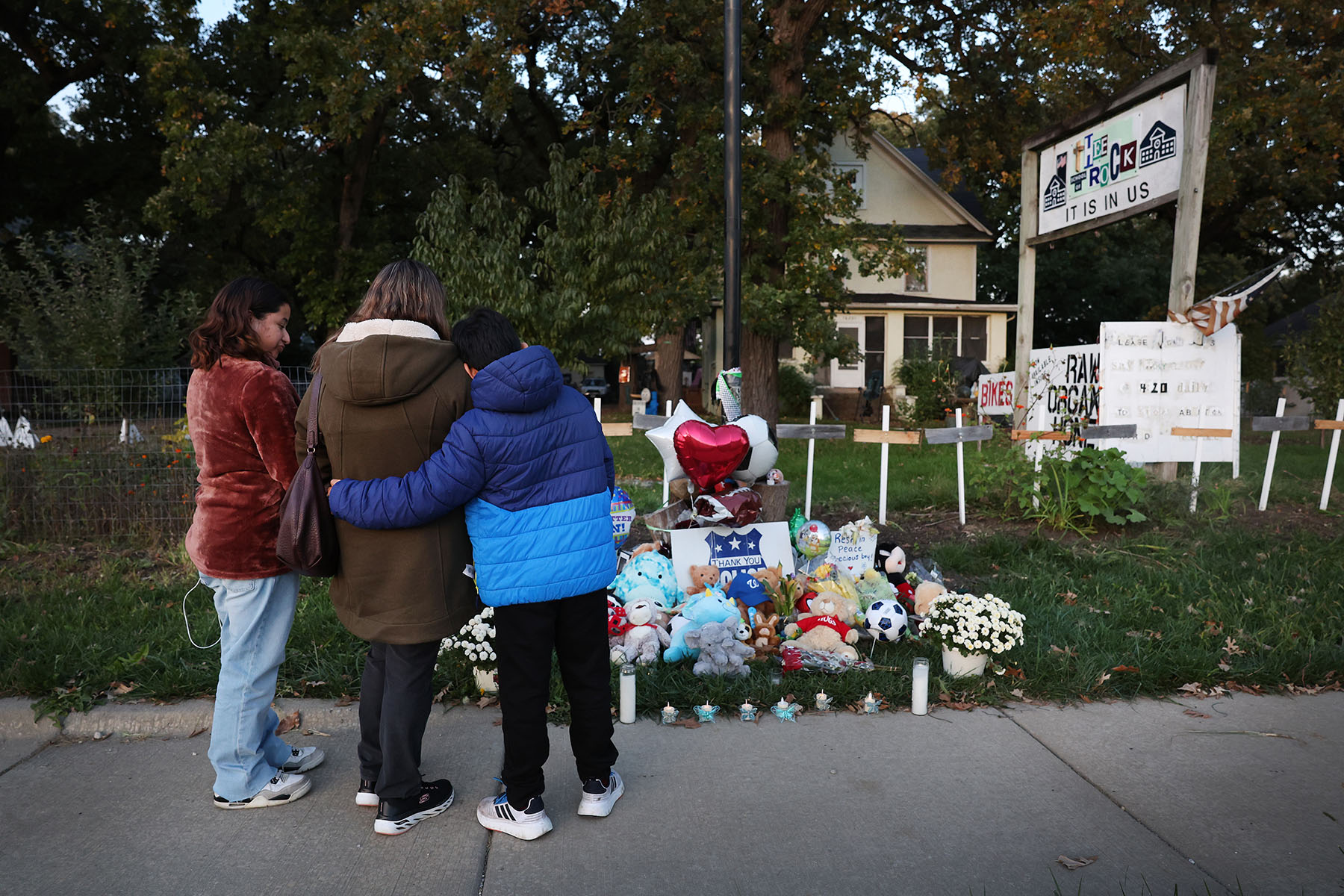 People visit a memorial in front of the home where Wadea Al-Fayoume, a 6-year-old Palestinian-American boy, was stabbed to death by his landlord.