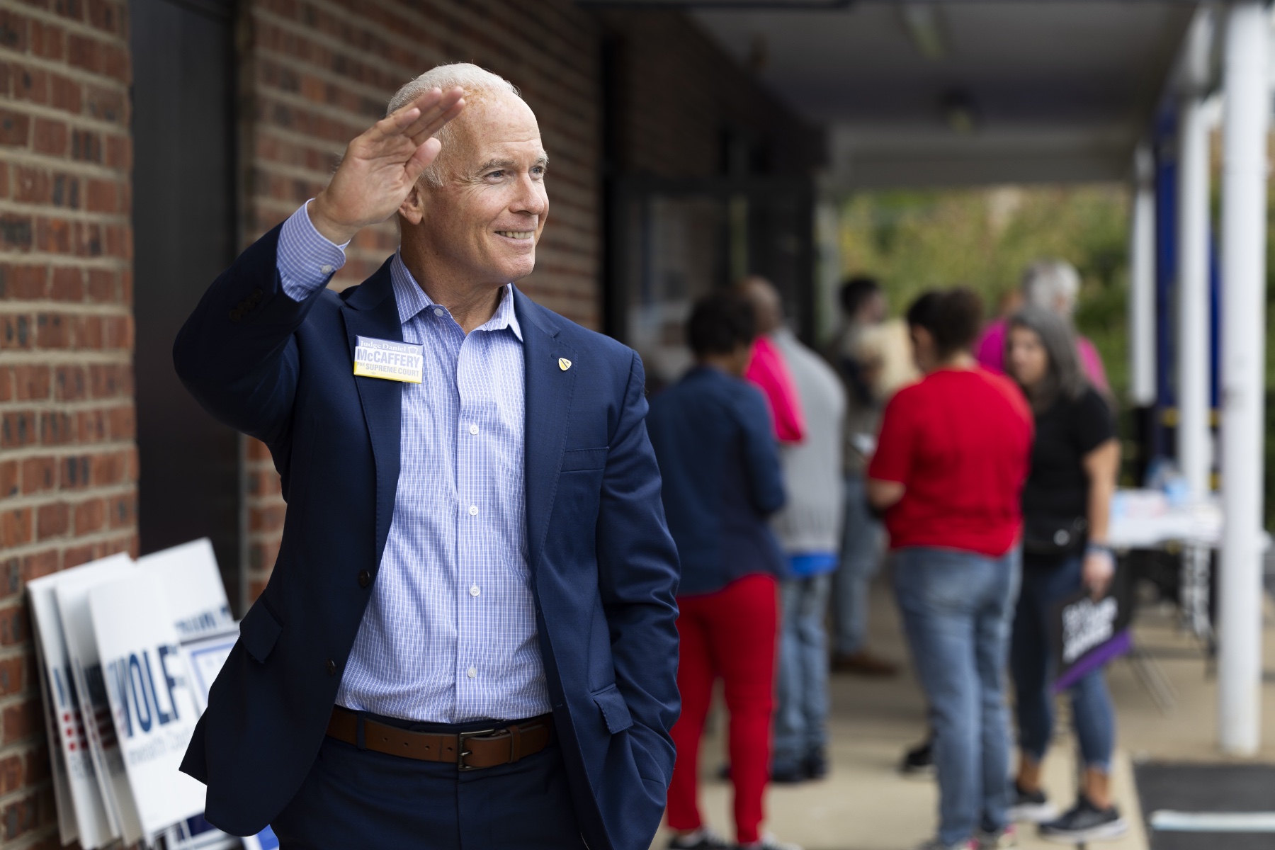 Democratic candidate for Pennsylvania Supreme Court Daniel McCaffery waves while wearing a navy blue suit.