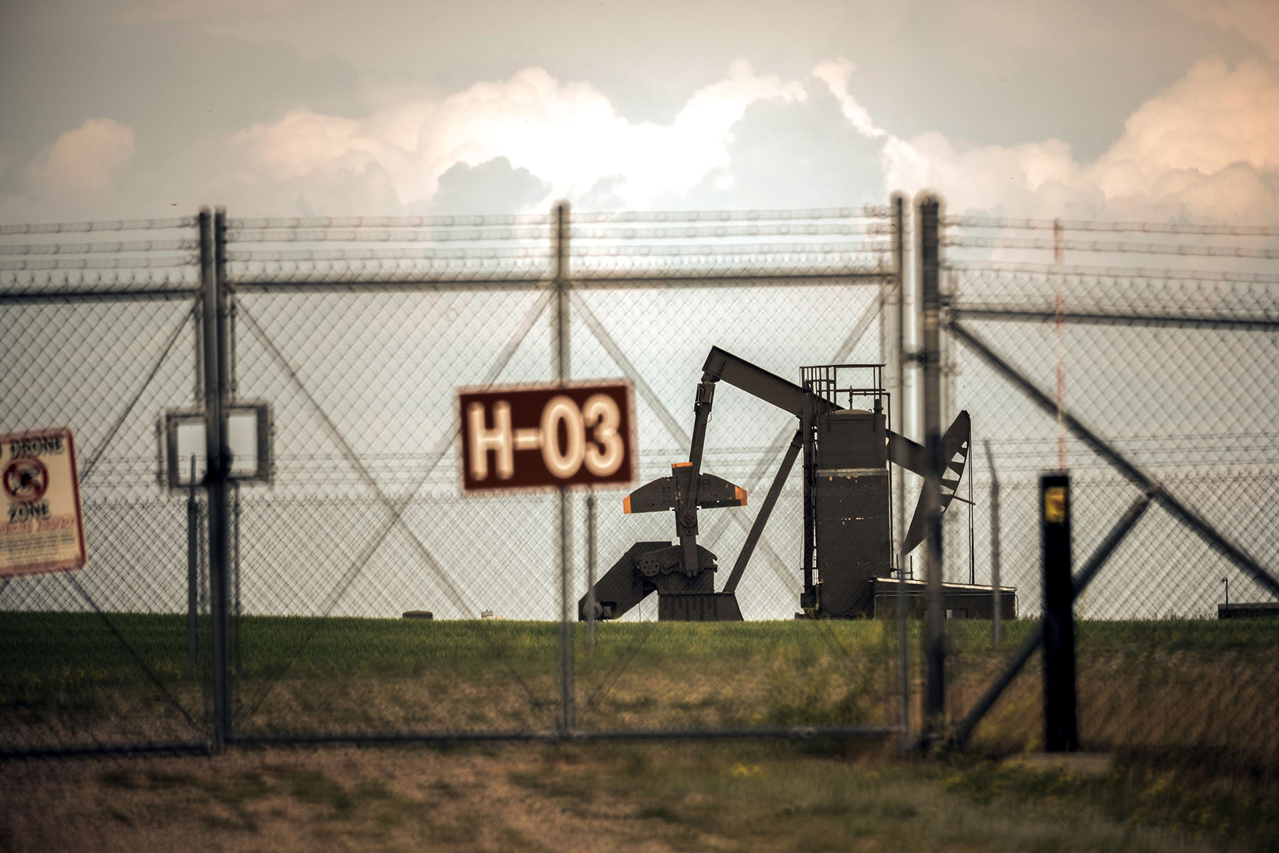 A missile silo and a drilling rig are seen in Parshall, North Dakota.