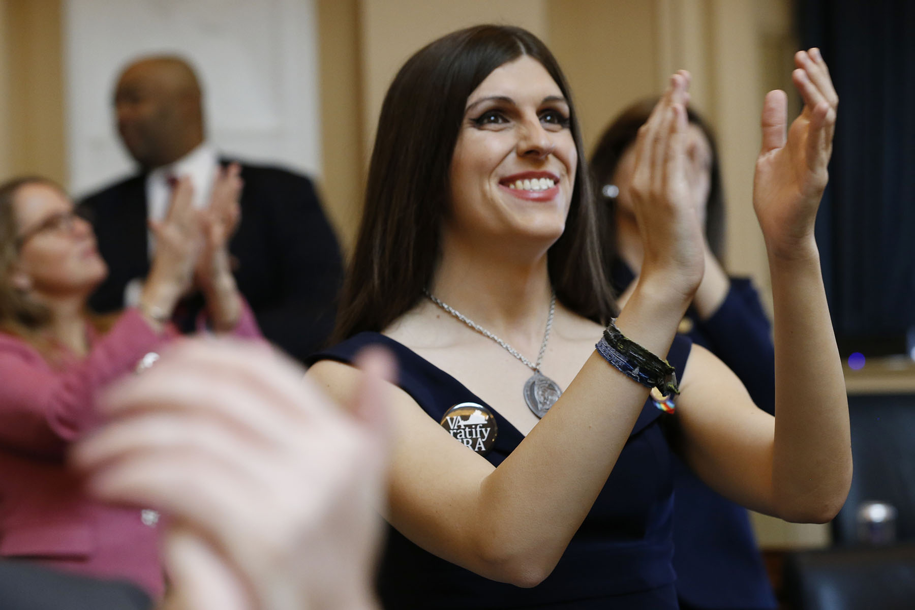 Danica Roem smiles and applauds visitors during opening ceremonies at the start of the 2019 session of the Virginia General Assembly in the House chambers at the Capitol in Richmond, Virginia.