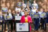 HRC President Kelley Robinson speaks in front of candidates holding signs in Virginia